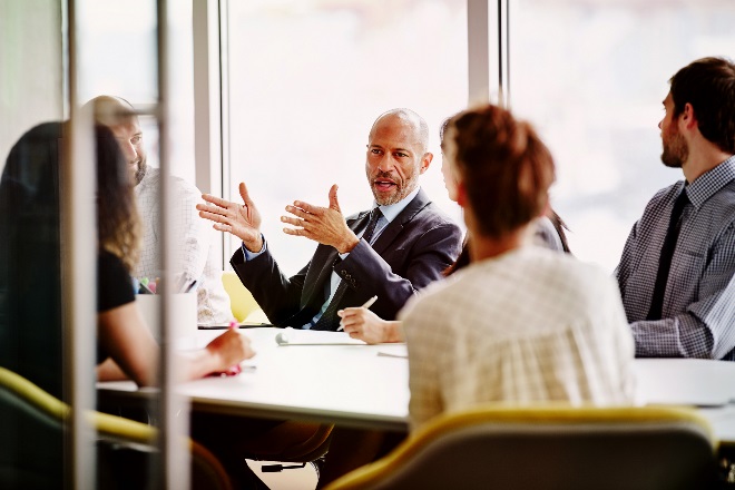 A group of people in a large room talking