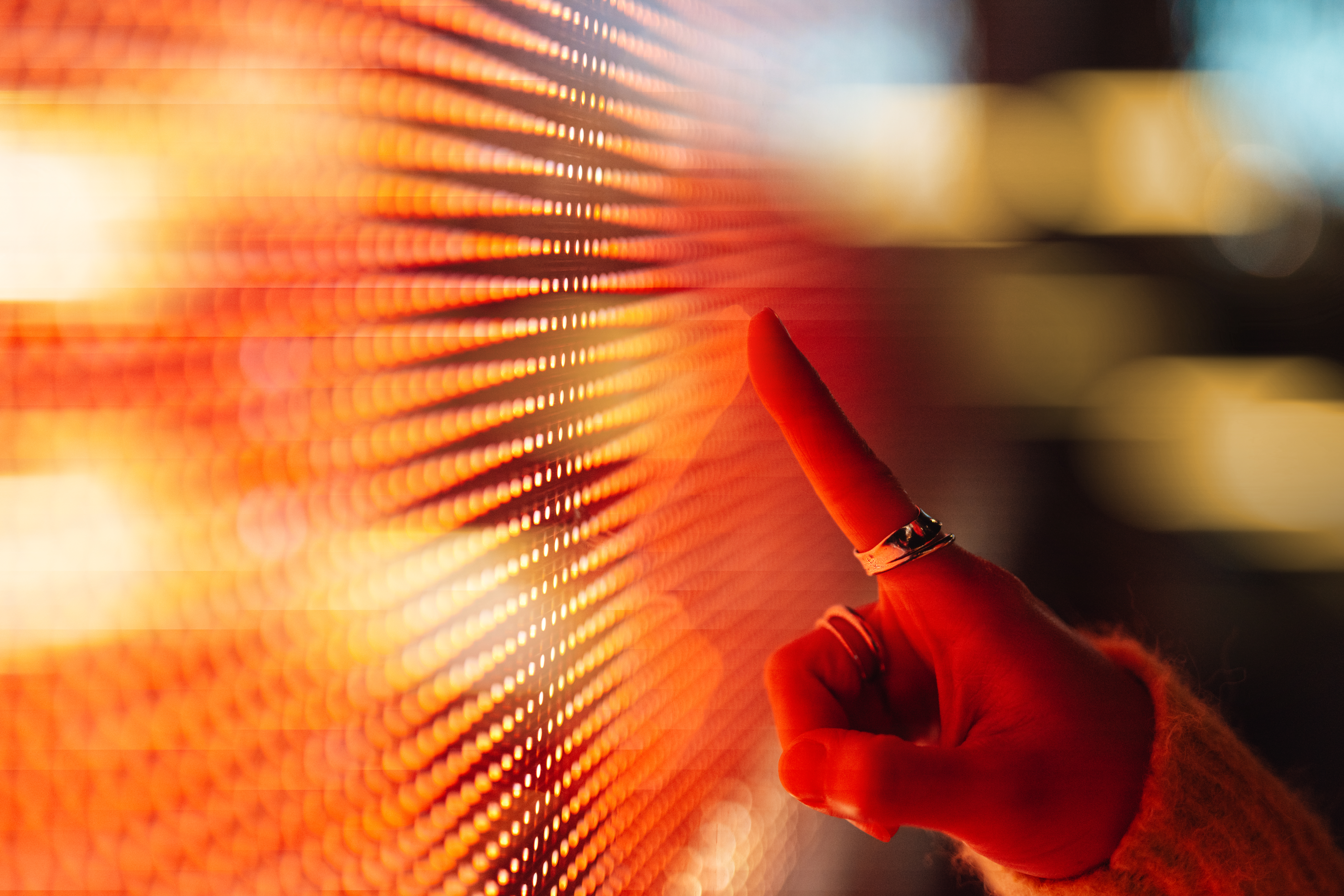 A person pointing at a light screen
