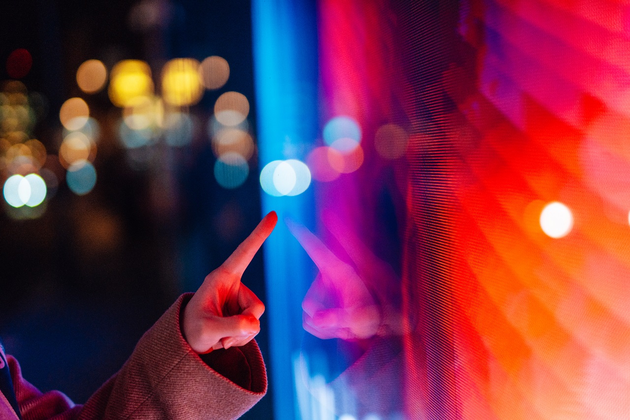 A finger pointing at a red-tinted screen