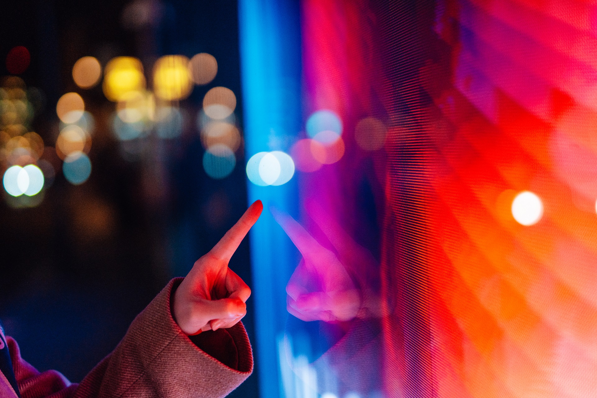 A finger pointing at a red-tinted screen