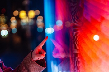 A finger pointing at a red-tinted screen