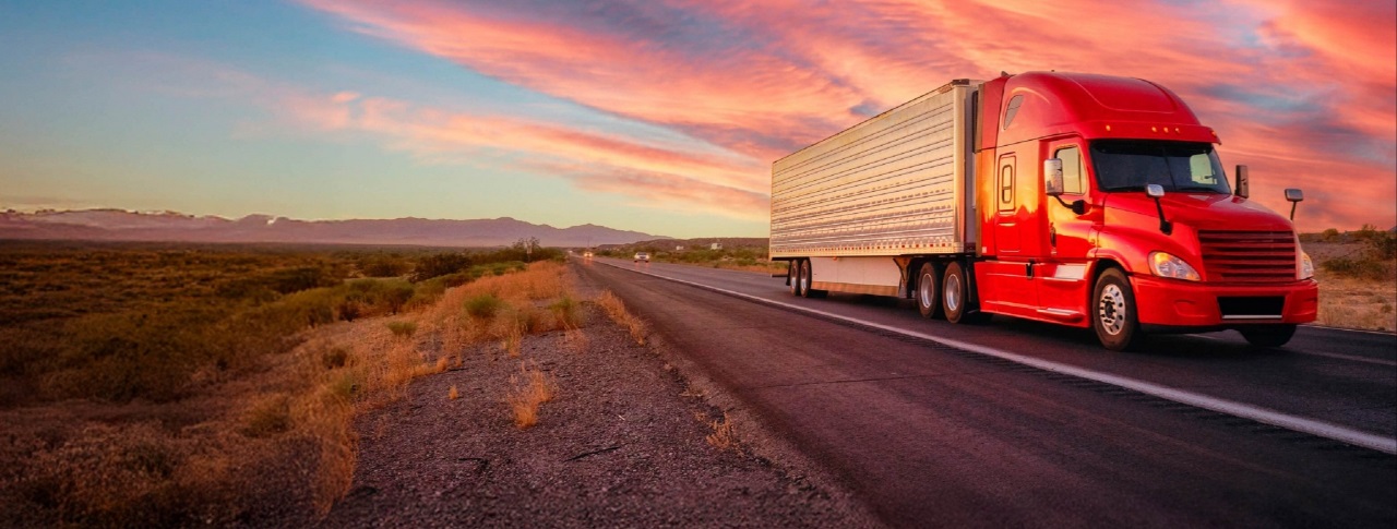 A commercial marine vehicle traveling on the sea at the sunset