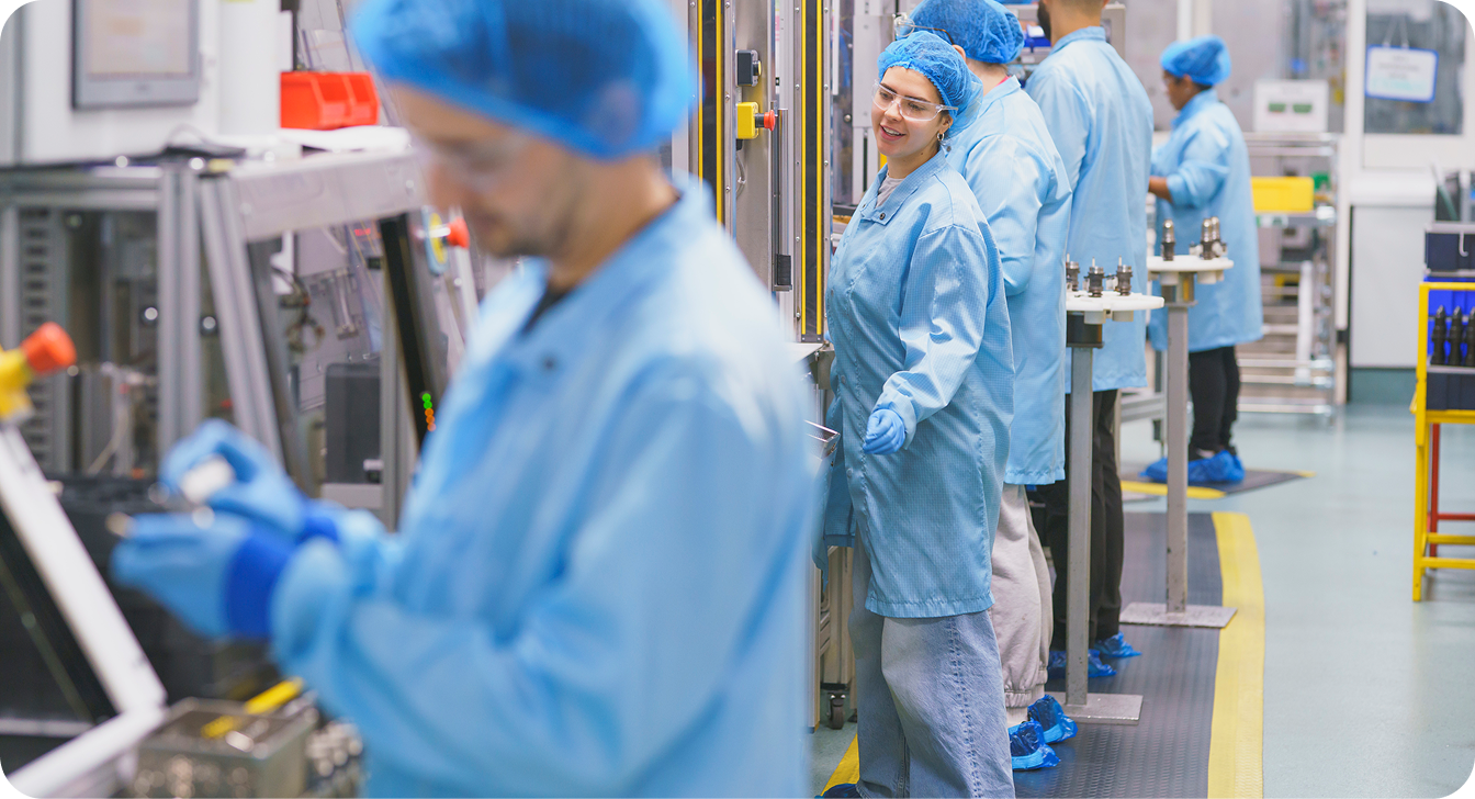 Manufacturing employees carrying out quality inspection on a production line.