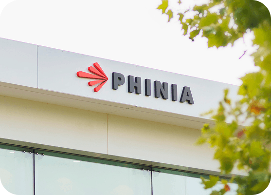 Exterior view of a PHINIA plant with company signage.