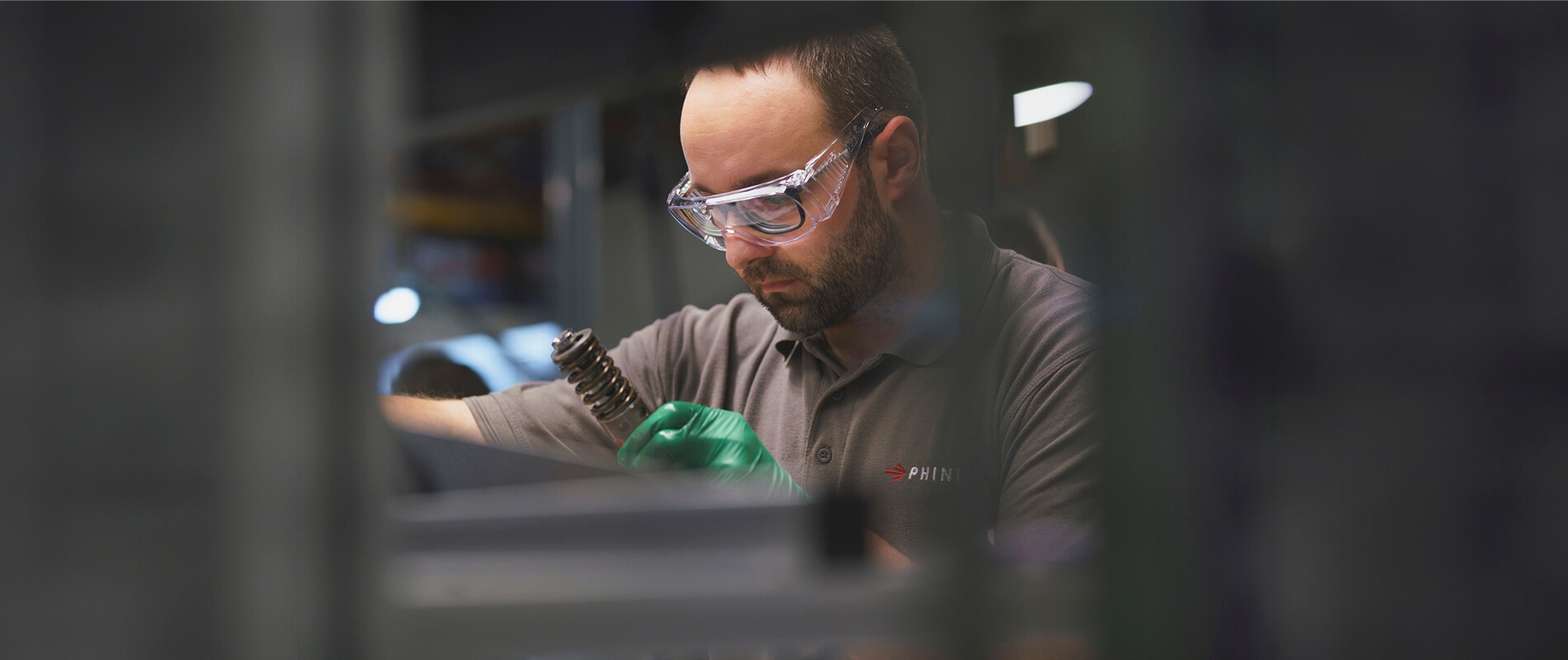 Engineer inspecting production equipment at an industrial facility.