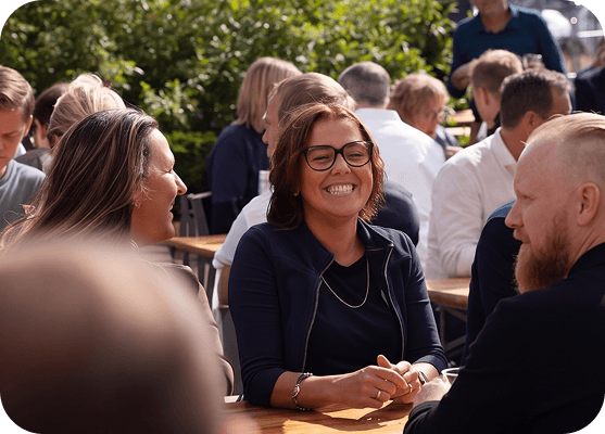 Employees talking and networking at a company social event.