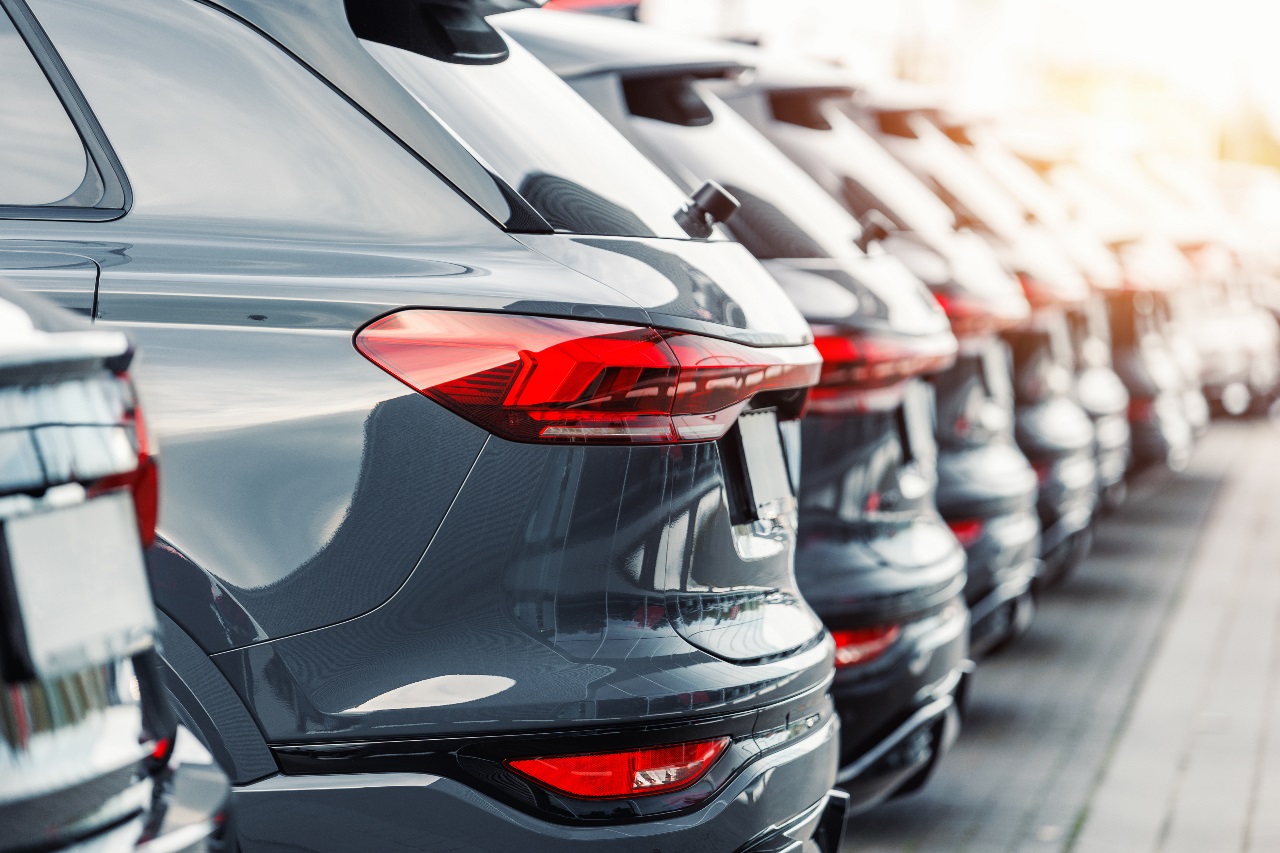 Row of brand-new modern SUV cars parked at a dealership lot, highlighting automotive design, car sales, and dealership inventory themes.